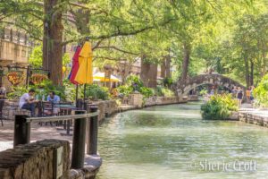 A view of the river, cafes and a bridge at the River Walk in downtown San Antonio, Texas.